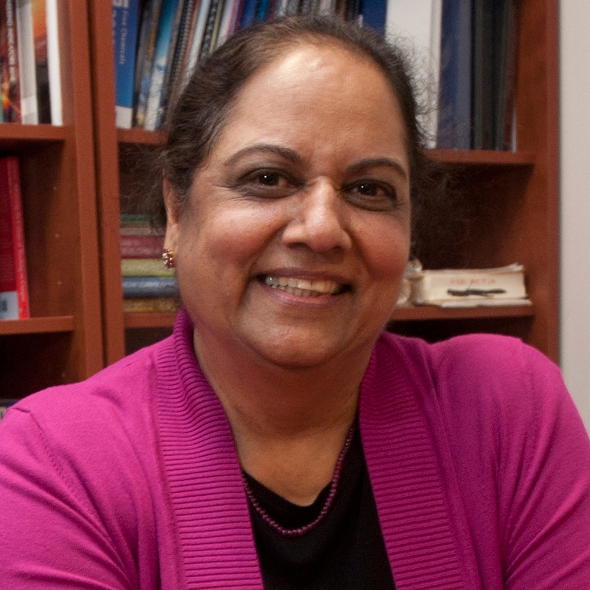 Portrait of Pratibha Varma-Nelson smiling at the camera.